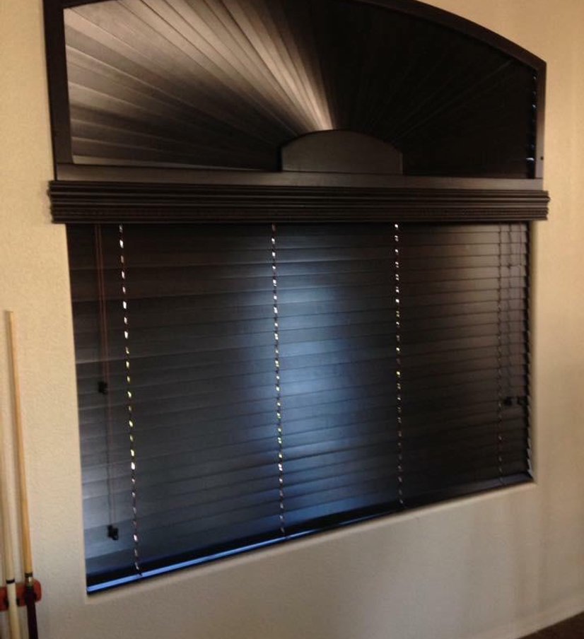 dark wood blinds with an arched sunburst window topper in a game room