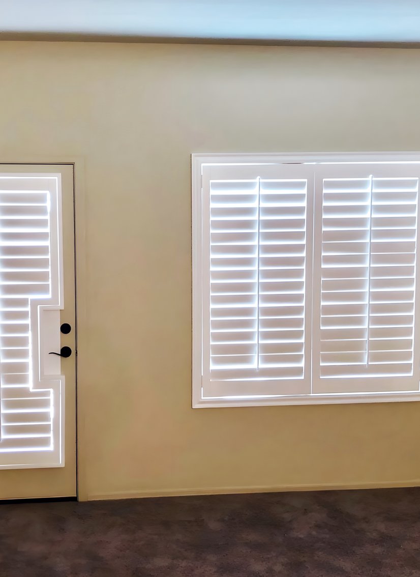 white plantation shutters on a back door and adjacent window