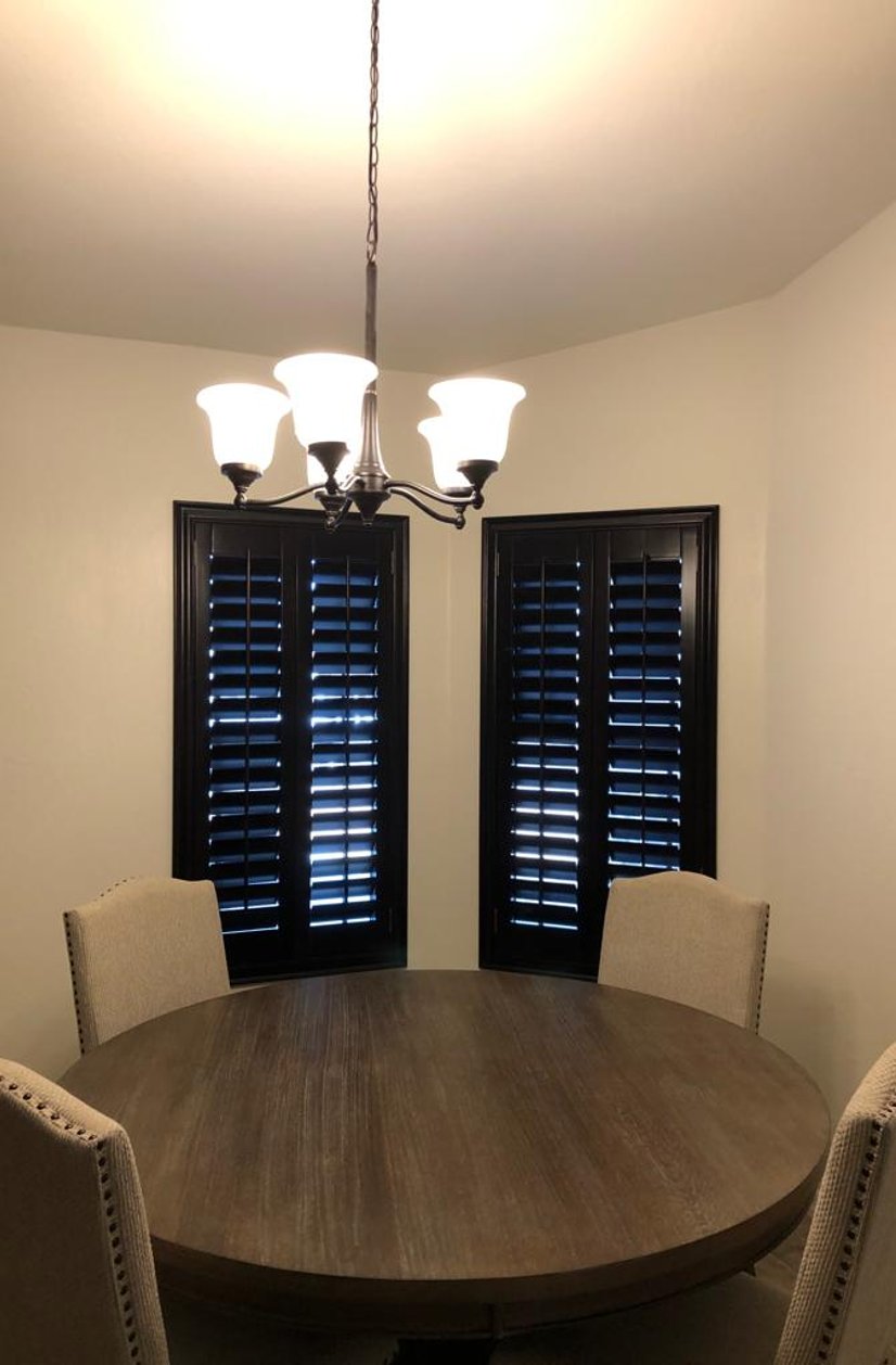 dark stained plantation shutters in a breakfast nook